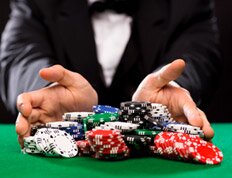 Man in Black Suit Pushing Poker Chips