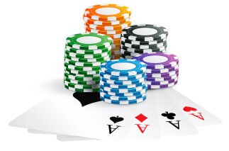 Multi-Colored Chips and Four Aces Playing Cards